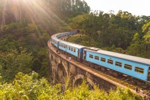 Blue train crossing the Nine Arch Bridge near Ella, Sri Lanka