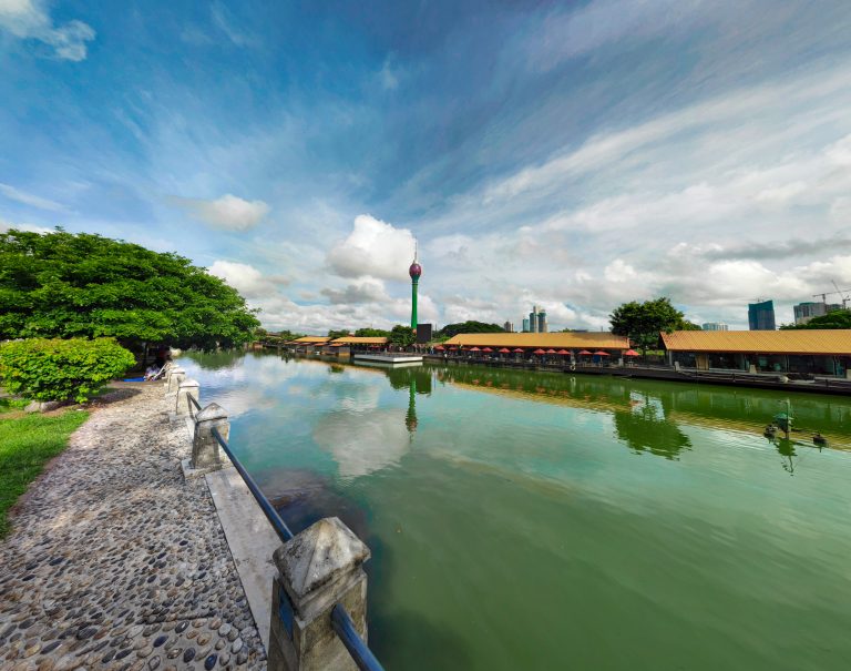 The Lotus Tower seen across Beira Lake from the stone-paved lakeside path