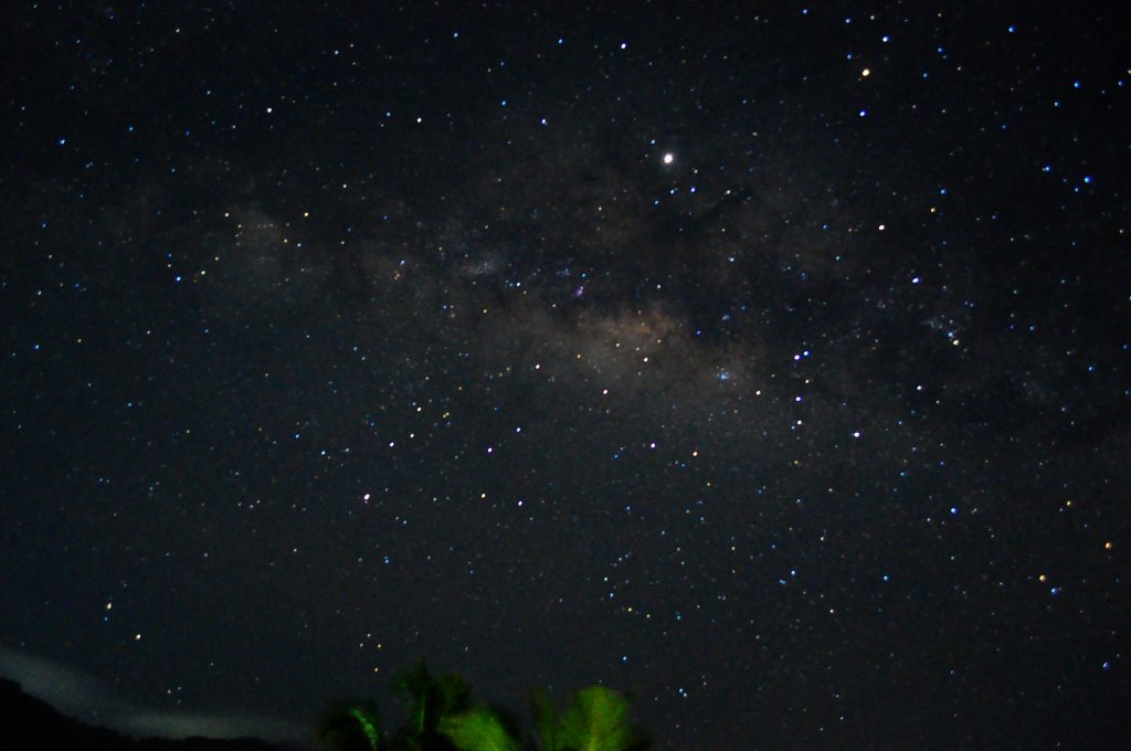 The Milky Way rising over the dark silhouette of trees on the Hanthana hills near Kandy