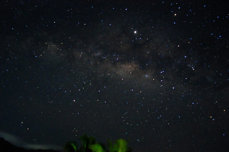 The Milky Way rising over the dark silhouette of trees on the Hanthana hills near Kandy