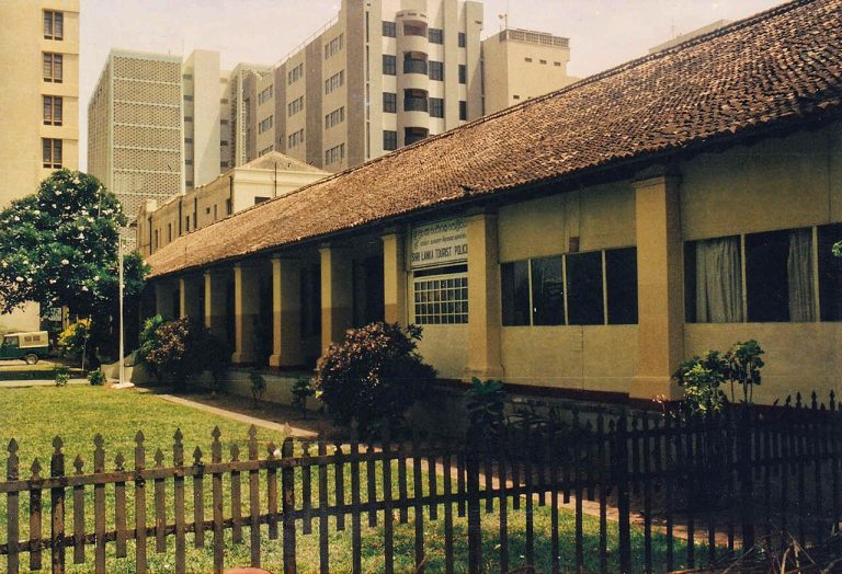 The long tiled roof and veranda of the Dutch hospital in Colombo Fort in 1992, before its restoration, with modern office blocks behind